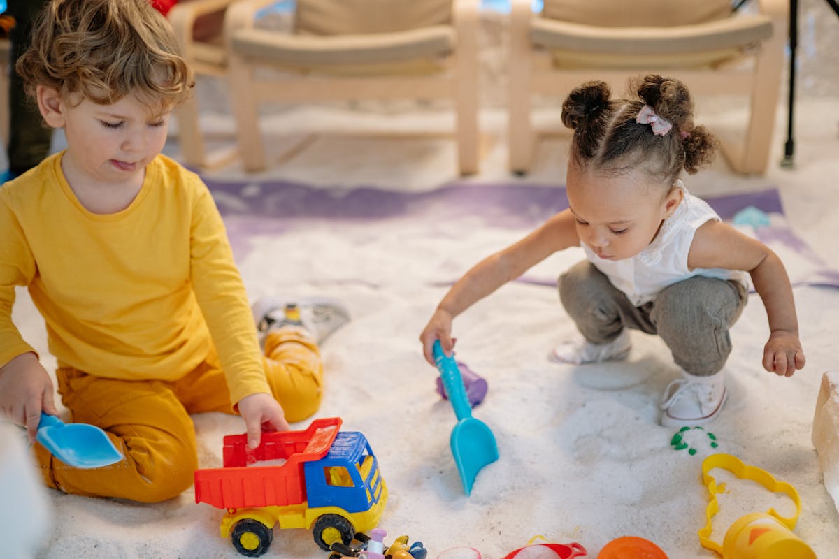 Young children playing with educational toys in an early years setting